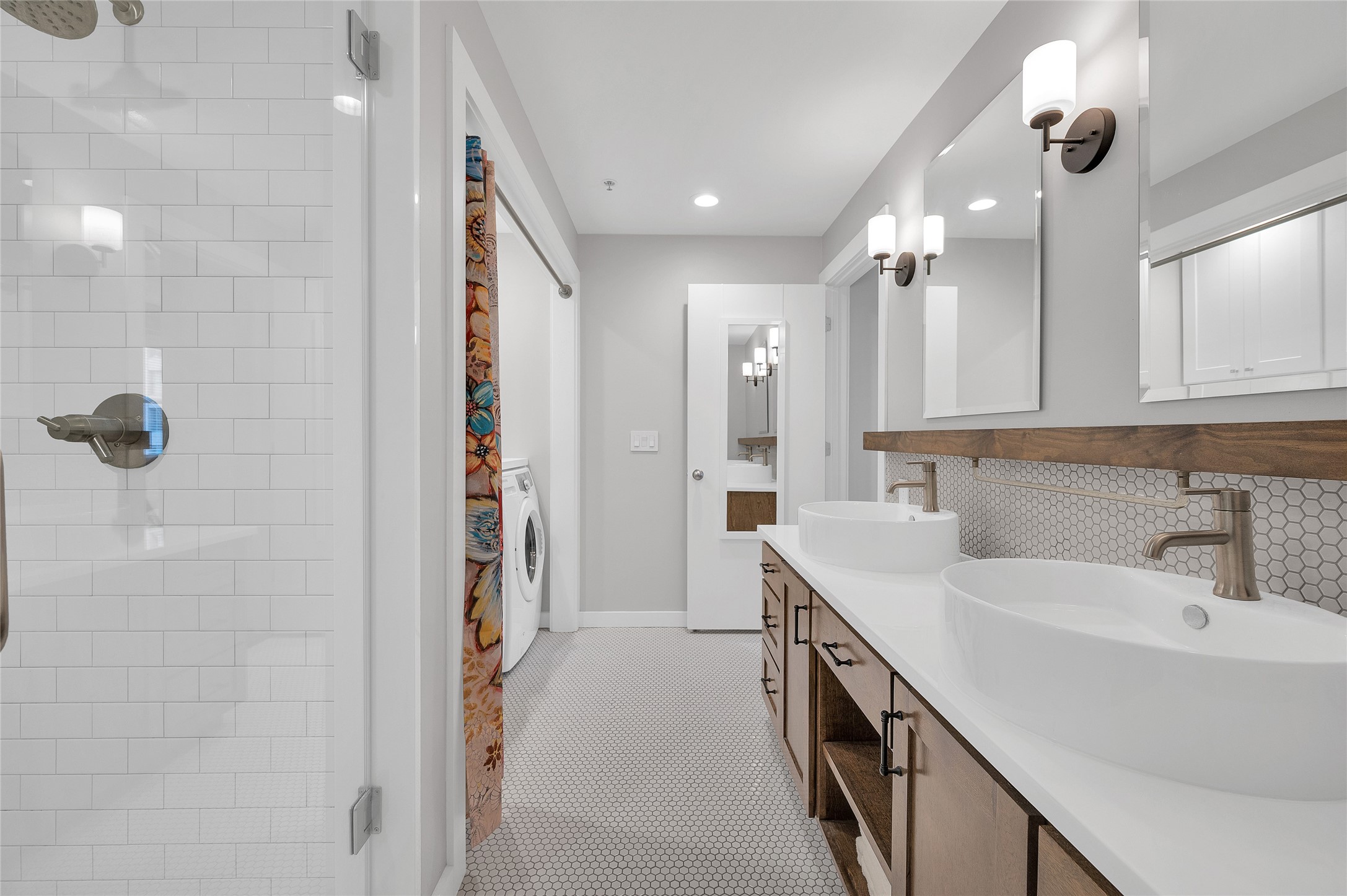 204 Travis Street, Unit 4A Houston, TX 77002 - Photo 17 of 34 a bathroom with a double vanity sink a mirror and shower