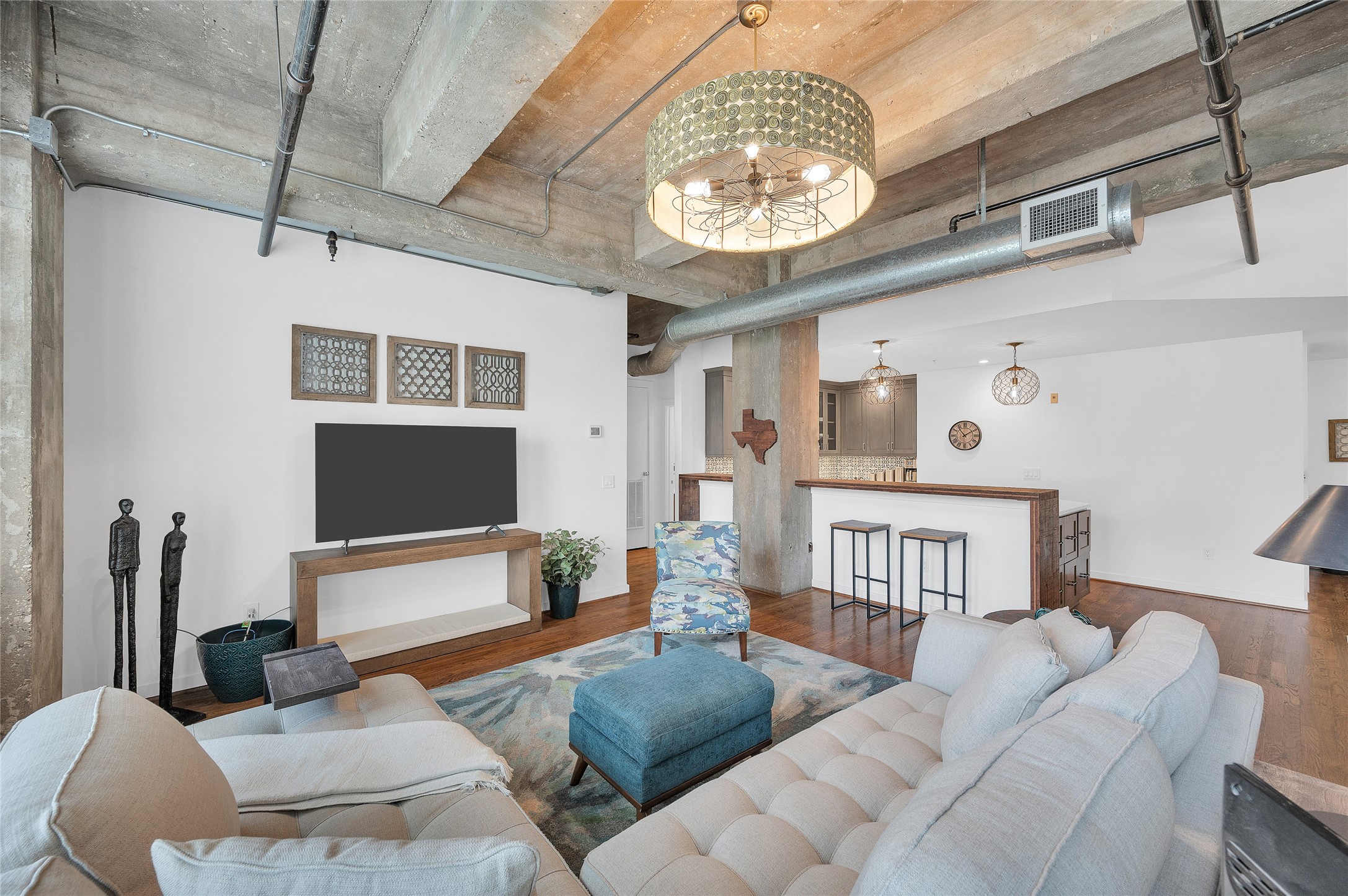 204 Travis Street, Unit 4A Houston, TX 77002 - Photo 2 of 34 a living room with furniture and a chandelier