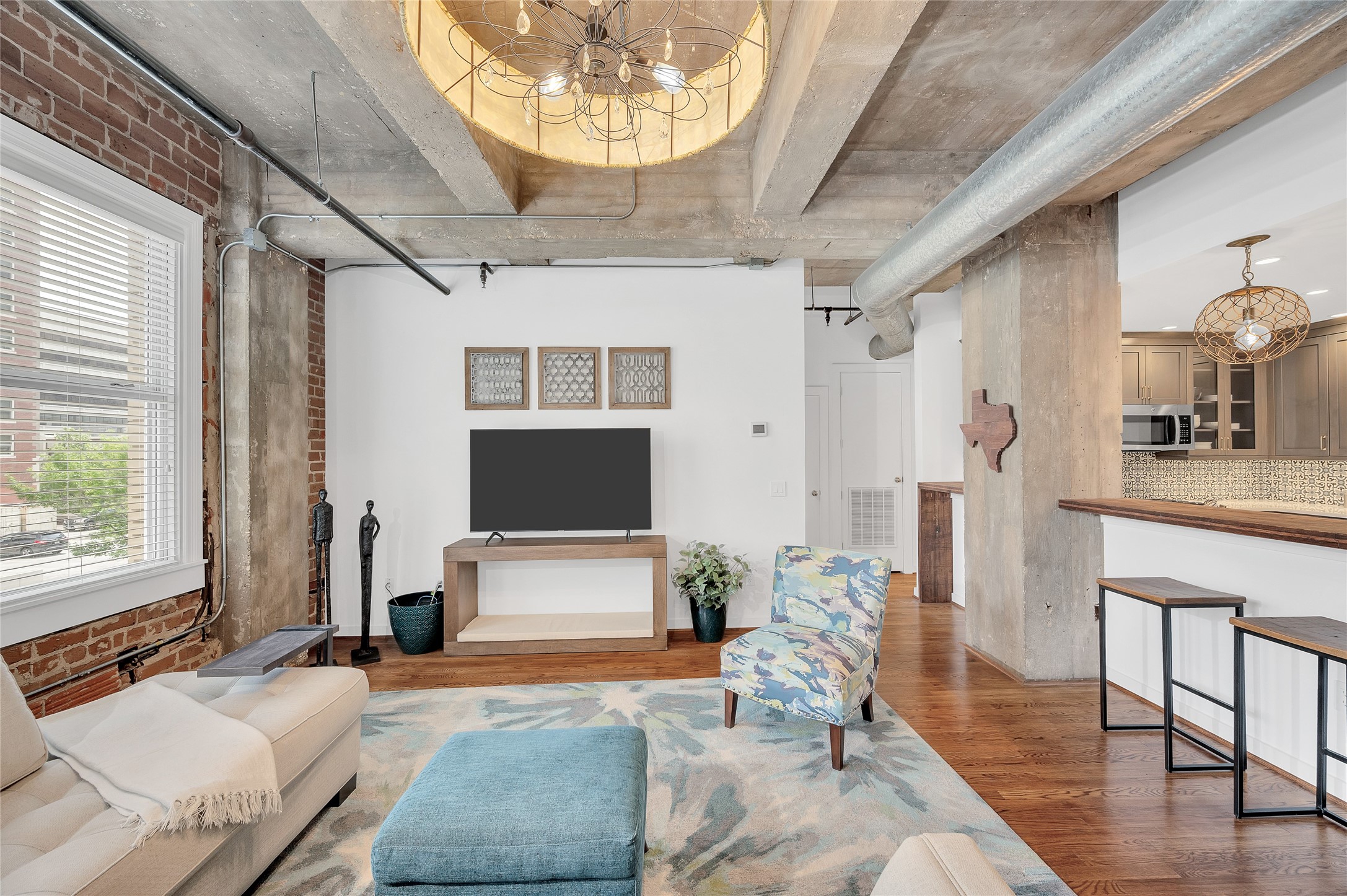 204 Travis Street, Unit 4A Houston, TX 77002 - Photo 3 of 34 a living room with furniture and a flat screen tv