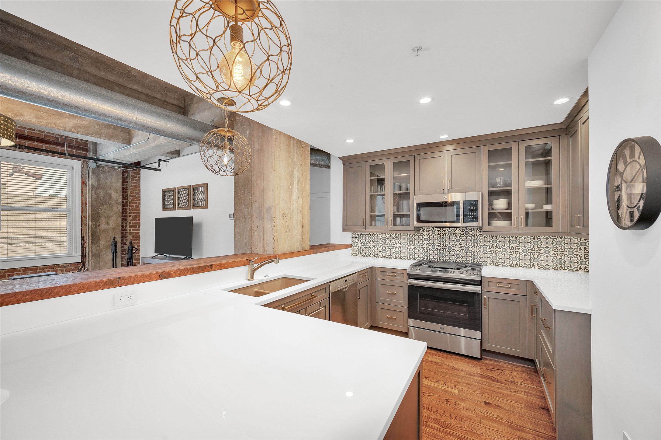 204 Travis Street, Unit 4A Houston, TX 77002 - Photo 7 of 34 a kitchen with stainless steel appliances granite countertop a sink and stove
