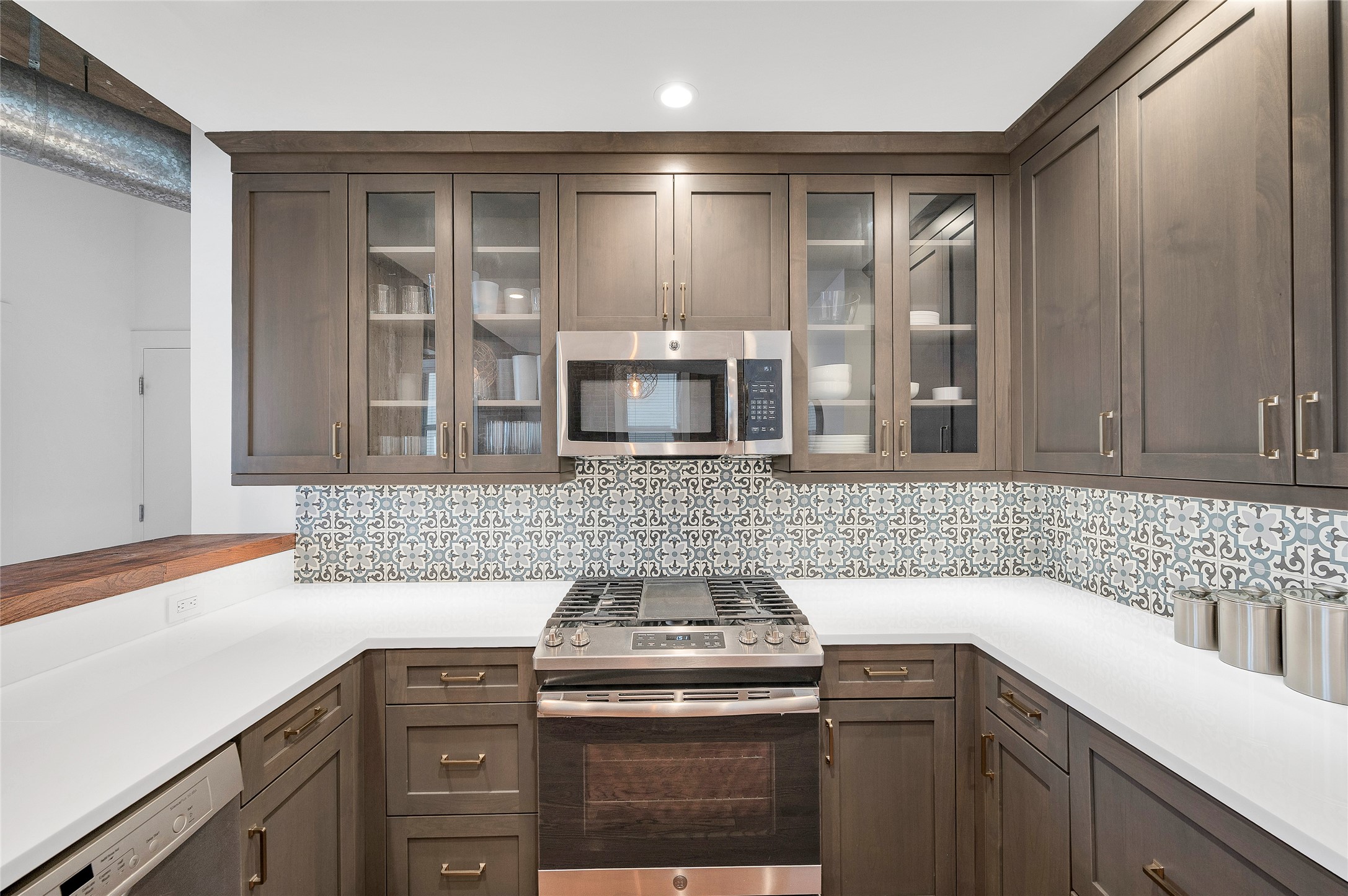 204 Travis Street, Unit 4A Houston, TX 77002 - Photo 9 of 34 a kitchen with stainless steel appliances granite countertop a sink and a stove