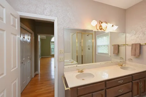 a bathroom with a sink double vanity and a mirror