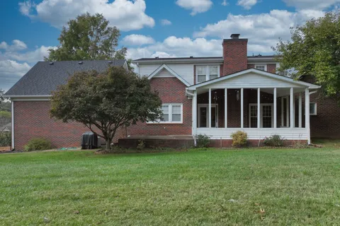 a view of house with yard and front view of a house