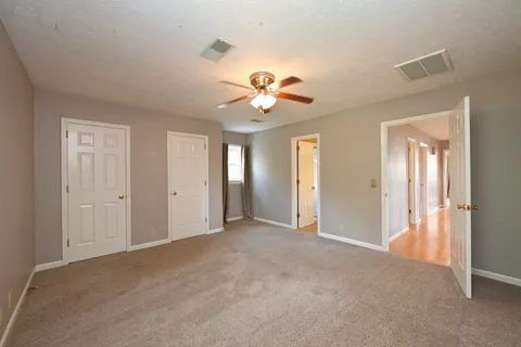 a view of an empty room with a ceiling fan