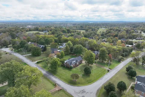 an aerial view of residential houses with outdoor space and swimming pool