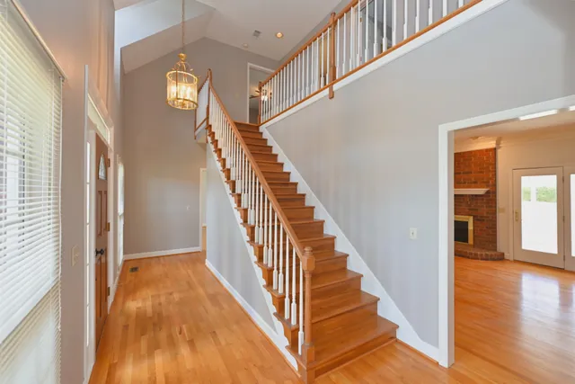 a kitchen with stainless steel appliances granite countertop a sink a stove and a refrigerator