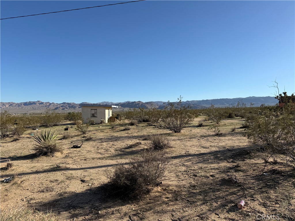 62823 Appian Way Joshua Tree, CA 92252 - Photo 19 of 25 a view of a yard with wooden fence