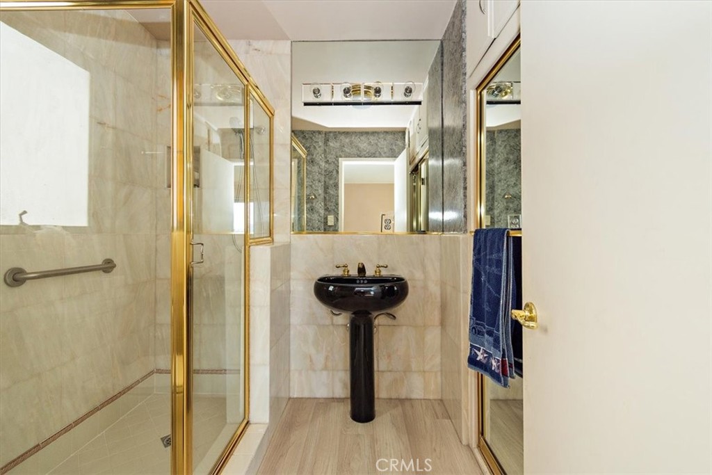 21 7th Place, Unit 409 Long Beach, CA 90802 - Photo 16 of 16 a view of a hallway with wooden floor and a bathroom