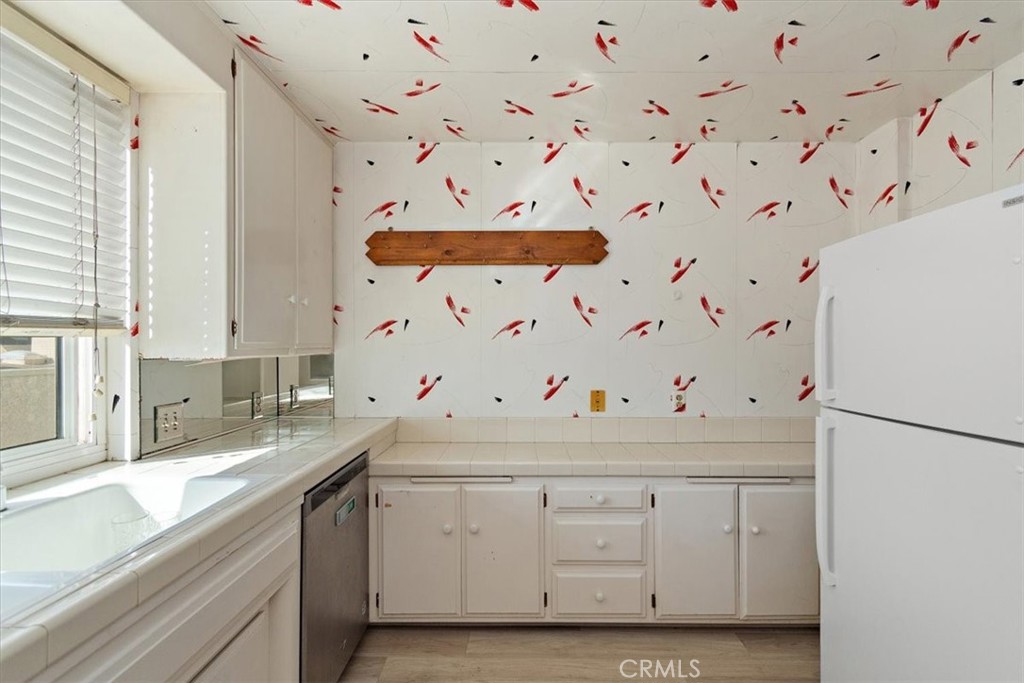 21 7th Place, Unit 409 Long Beach, CA 90802 - Photo 9 of 16 a utility room with cabinets washer and dryer
