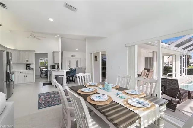 a view of a dining room and livingroom view with furniture wooden floor and a rug