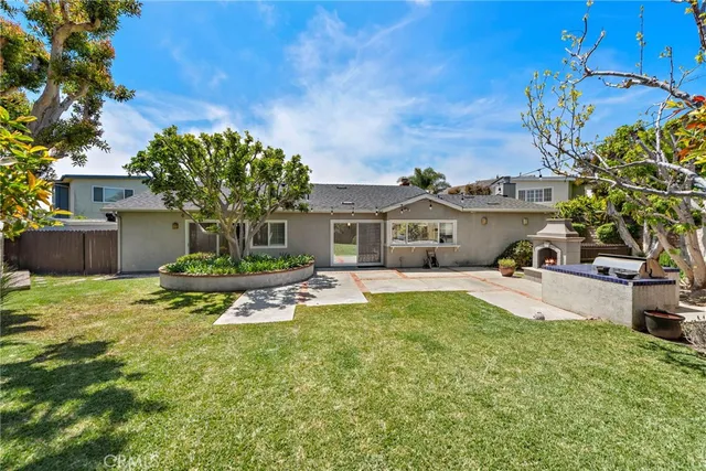 a view of a house with pool and a yard