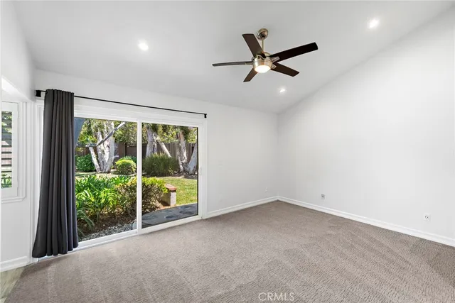 a view of a livingroom with a ceiling fan and window