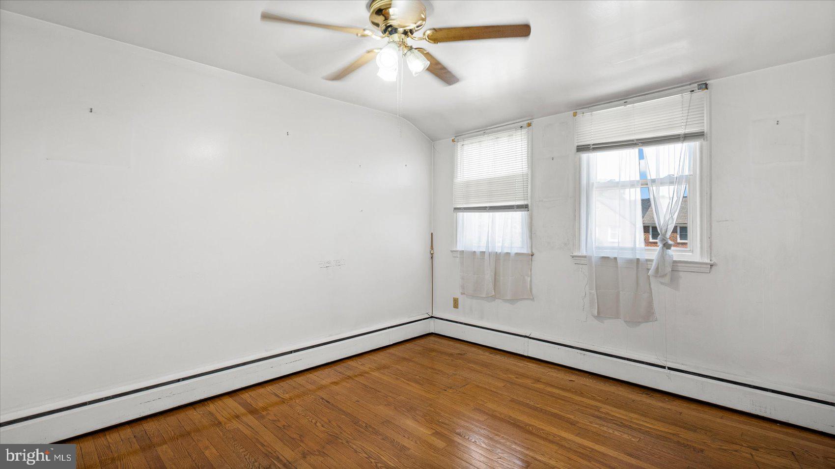 1805 Crestview Road Baltimore, MD 21239 - Photo 22 of 39 an empty room with windows and fan