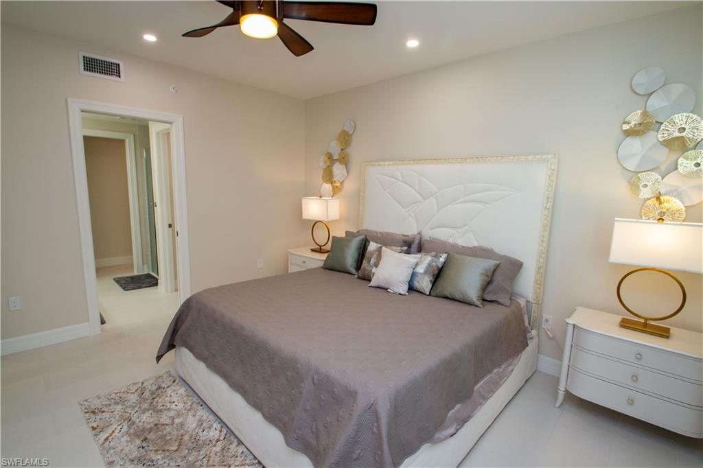 262 Indies Drive East, Unit 101 Naples, FL 34114 - Photo 11 of 32 a bedroom with a bed and window