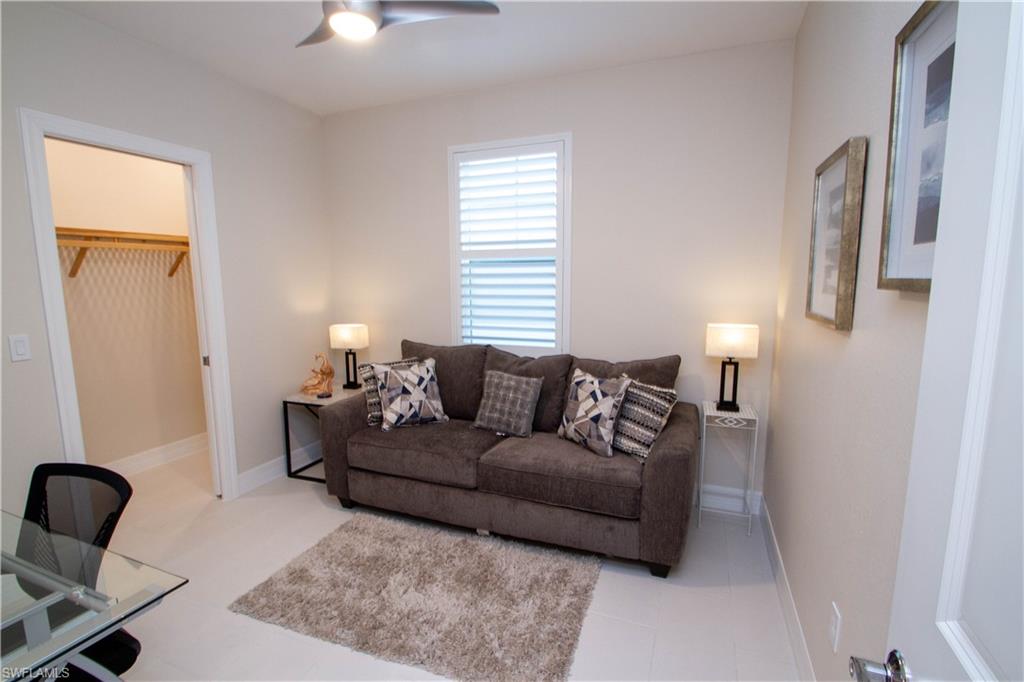 262 Indies Drive East, Unit 101 Naples, FL 34114 - Photo 20 of 32 a living room with furniture and a window