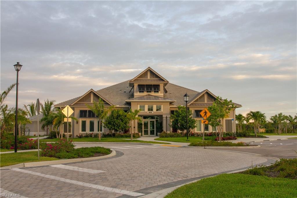 262 Indies Drive East, Unit 101 Naples, FL 34114 - Photo 23 of 32 a view of a big house with a big yard and large trees