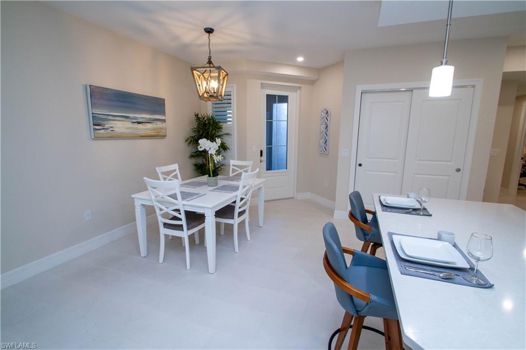 262 Indies Drive East, Unit 101 Naples, FL 34114 - Photo 4 of 32 a view of a dining room with furniture