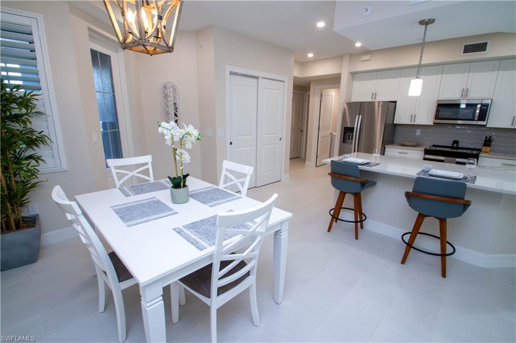 262 Indies Drive East, Unit 101 Naples, FL 34114 - Photo 5 of 32 a view of a dining room with furniture