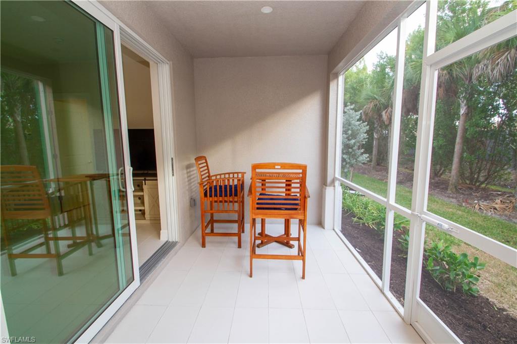 262 Indies Drive East, Unit 101 Naples, FL 34114 - Photo 7 of 32 a balcony with chairs
