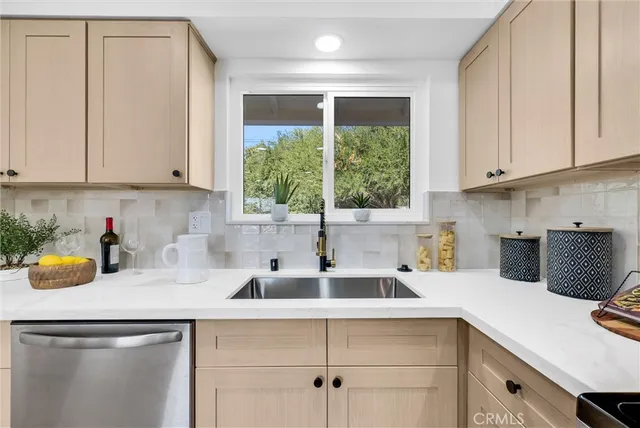 a kitchen with a sink cabinets and window