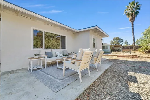 a building outdoor space with patio furniture and potted plants
