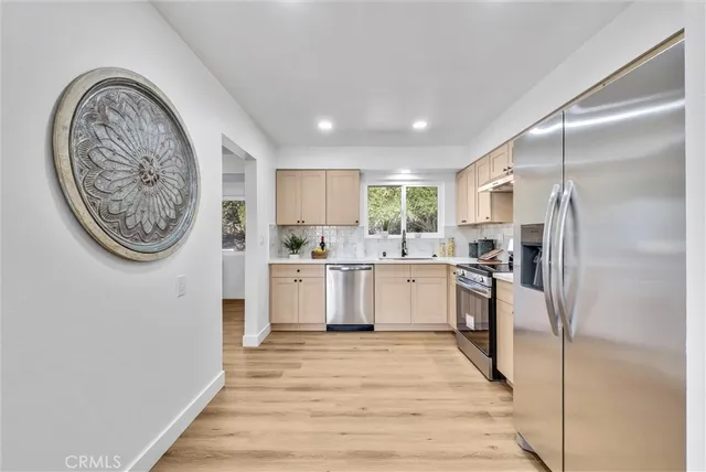 a kitchen with a refrigerator and a sink