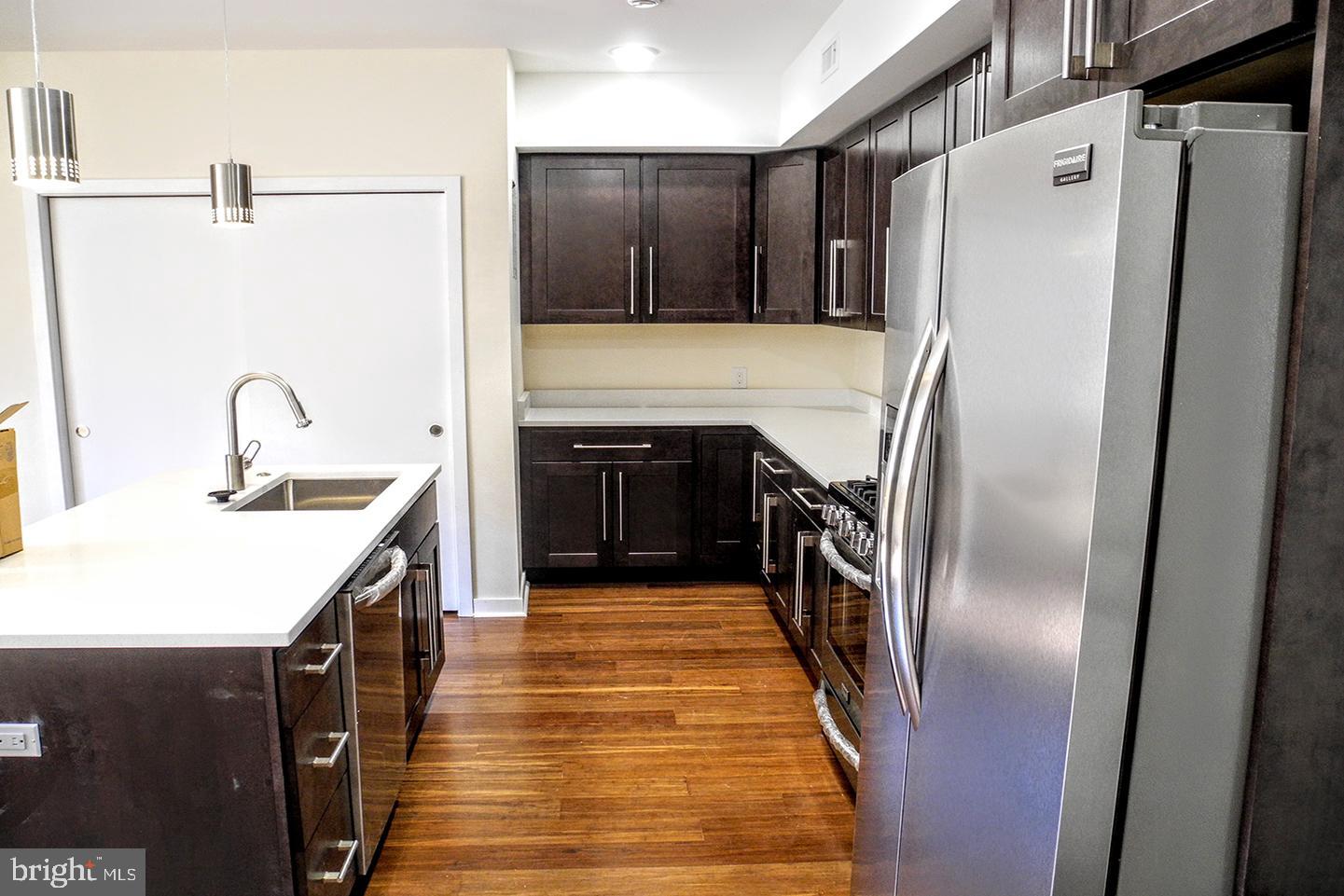 934 South 5th Street, Unit B2 Philadelphia, PA 19147 - Photo 4 of 11 a kitchen with stainless steel appliances a refrigerator and a sink
