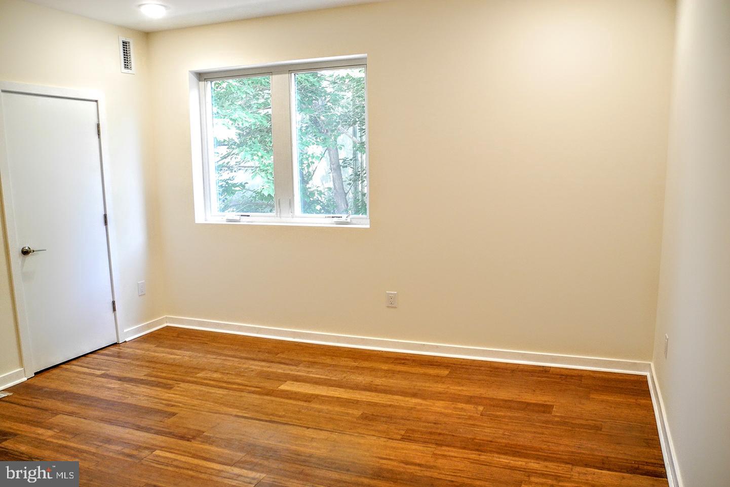 934 South 5th Street, Unit B2 Philadelphia, PA 19147 - Photo 10 of 11 an empty room with wooden floor and windows