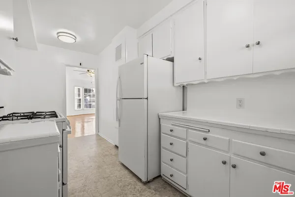 a kitchen with a stove and a refrigerator