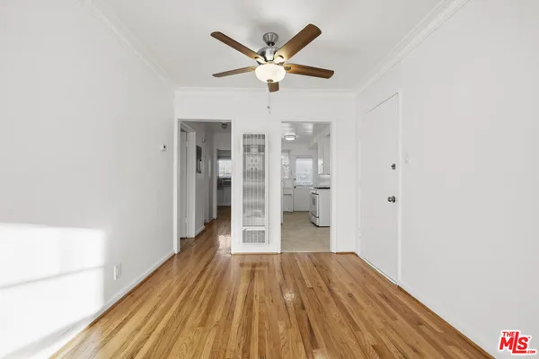 a view of empty room with wooden floor