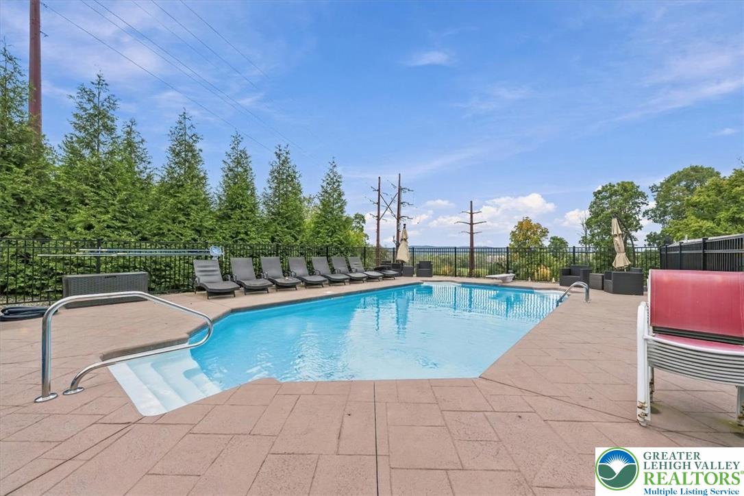 3771 State Road Coopersburg, PA 18036 - Photo 12 of 37 An inviting in-ground swimming pool is surrounded by a spacious paved patio and secure fencing.