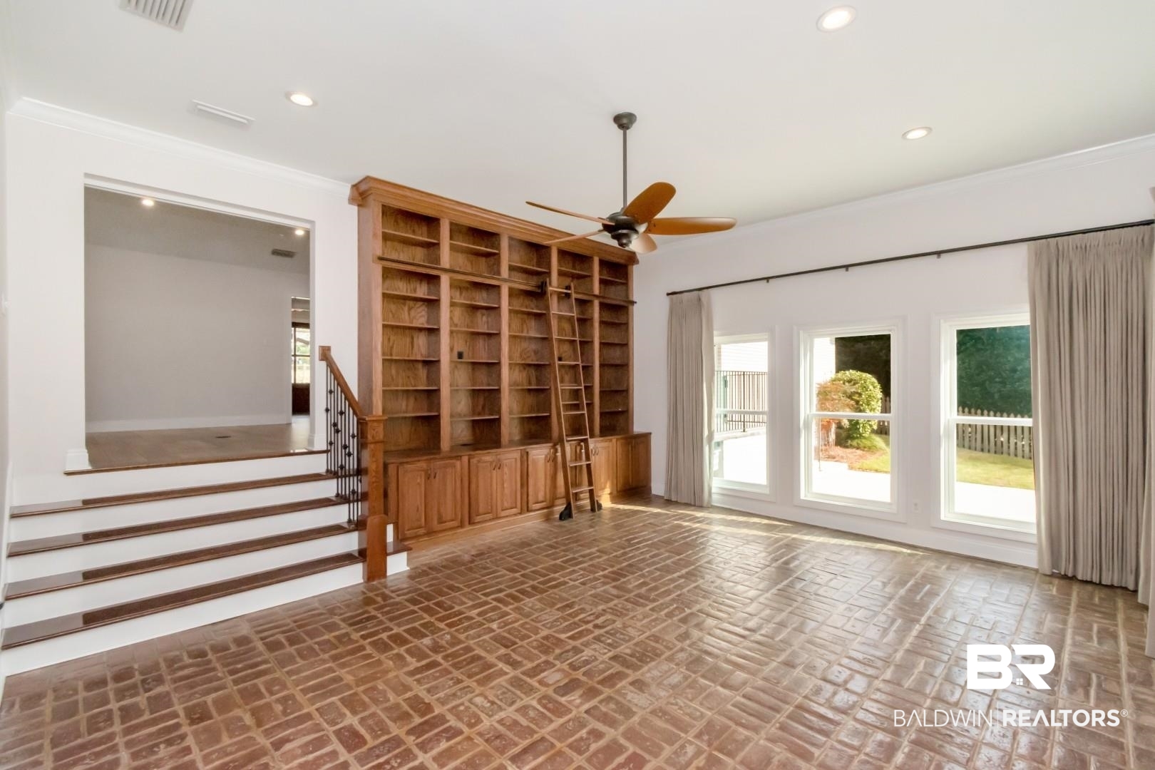 231 Rochester Road Mobile, AL 36608 - Photo 19 of 51 Empty room featuring brick flooring, healthy amount of natural light, a ceiling fan, and recessed lighting