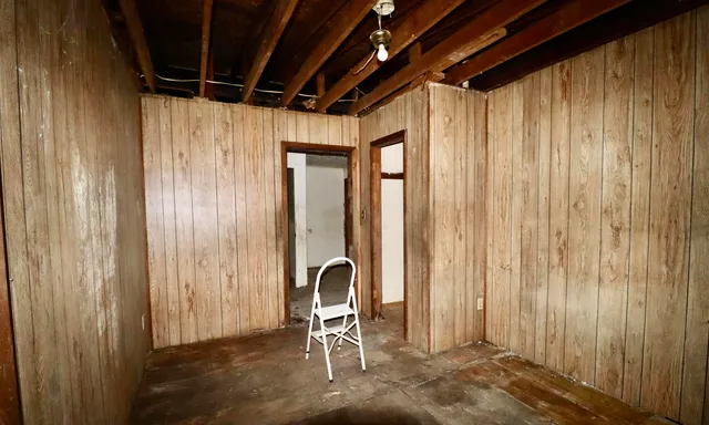 a view of a room with table and chairs
