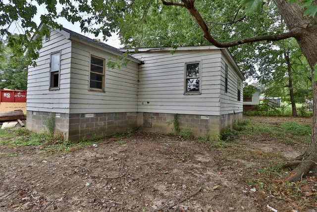a backyard of a house with table and chairs