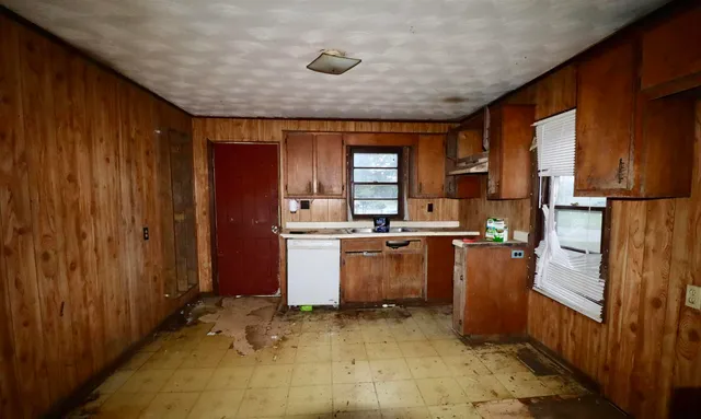 a room with sink and cabinets