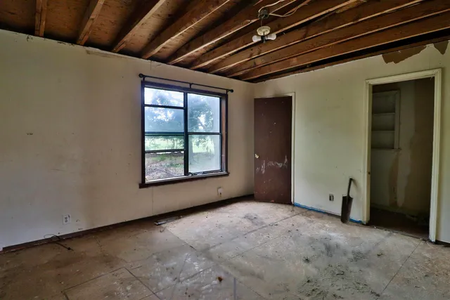 a view of an empty room with a window