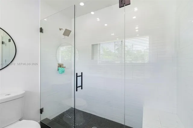 a bedroom with a bed and a potted plant