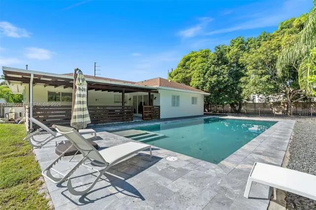 a view of a backyard with sitting area