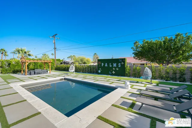 a view of swimming pool with lounge chair