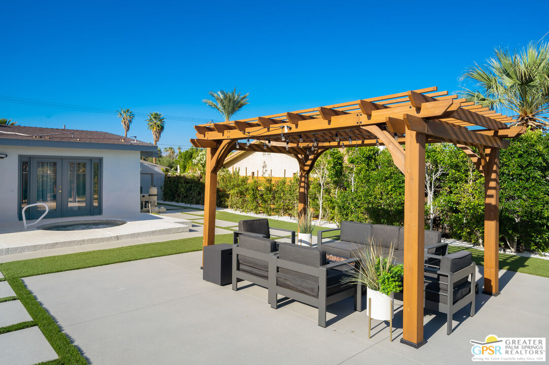 2775 East Verona Road Palm Springs, CA 92262 - Photo 24 of 73 a view of a patio with a table and chairs under an umbrella