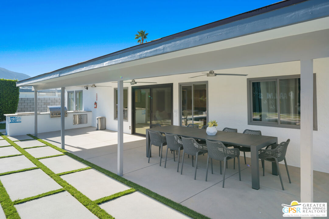 2775 East Verona Road Palm Springs, CA 92262 - Photo 25 of 73 a view of a dining hall with lots of furniture and wooden floor