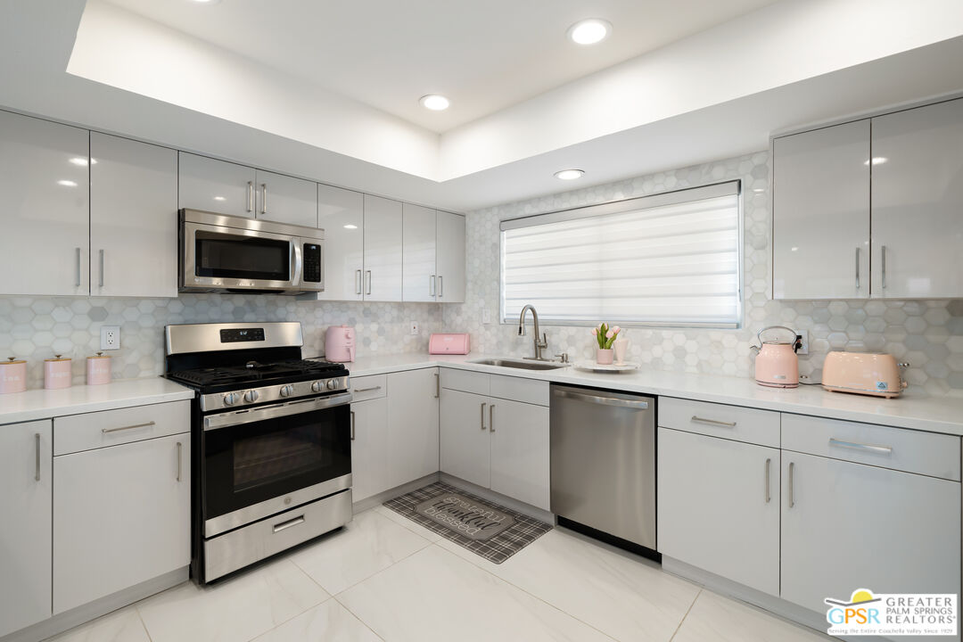 2775 East Verona Road Palm Springs, CA 92262 - Photo 36 of 73 a kitchen with sink cabinets and stainless steel appliances