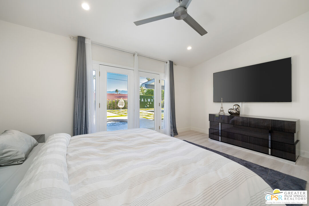 2775 East Verona Road Palm Springs, CA 92262 - Photo 46 of 73 a bedroom with a bed and a flat screen tv