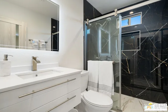 a patio with table and chairs and potted plants