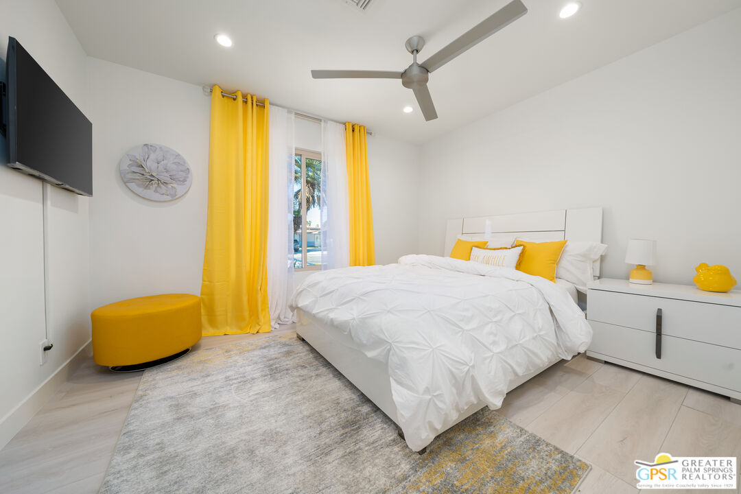 2775 East Verona Road Palm Springs, CA 92262 - Photo 50 of 73 a bedroom with a bed window and a flat screen tv