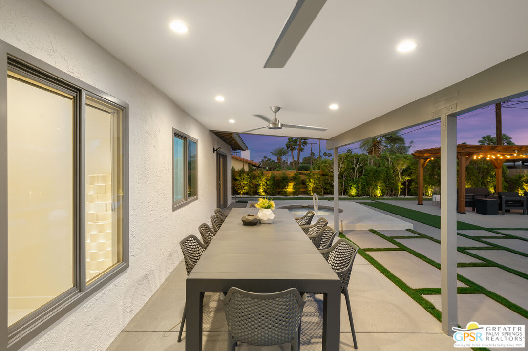 2775 East Verona Road Palm Springs, CA 92262 - Photo 57 of 73 a view of a dining room with furniture large windows and outside view