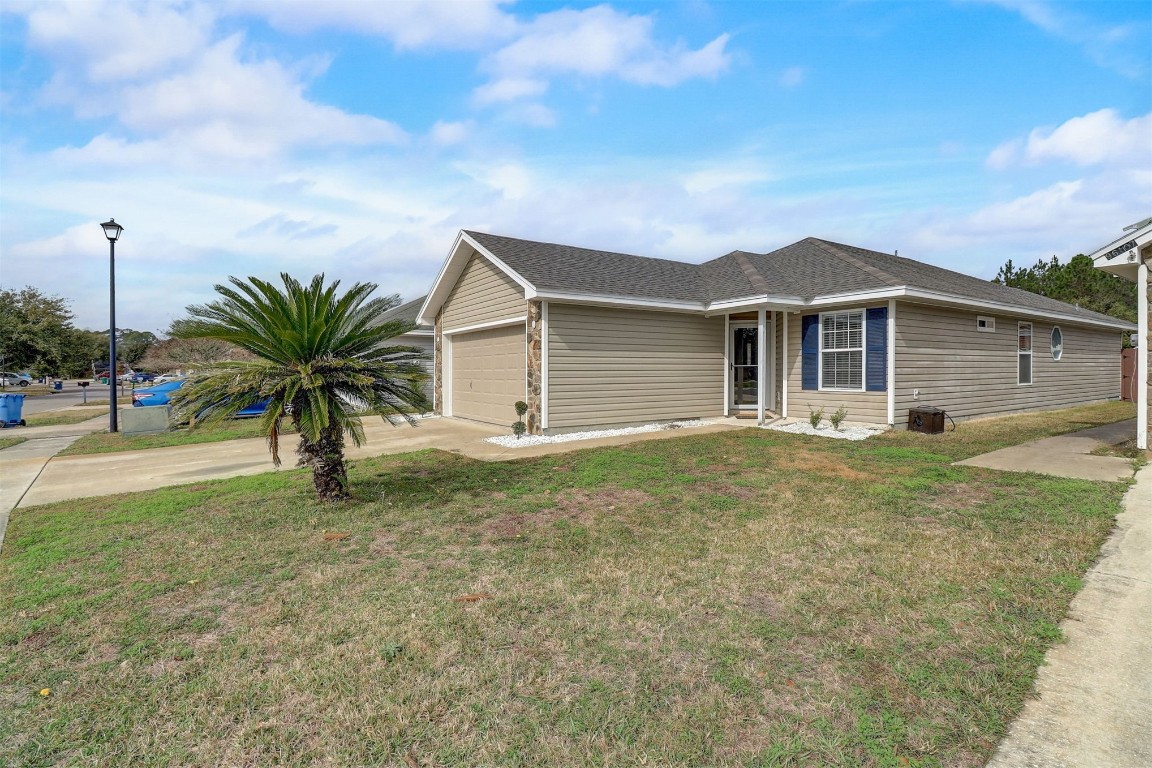 96099 Starlight Lane Yulee, FL 32097 - Photo 2 of 36 a view of a house with a yard and potted plants