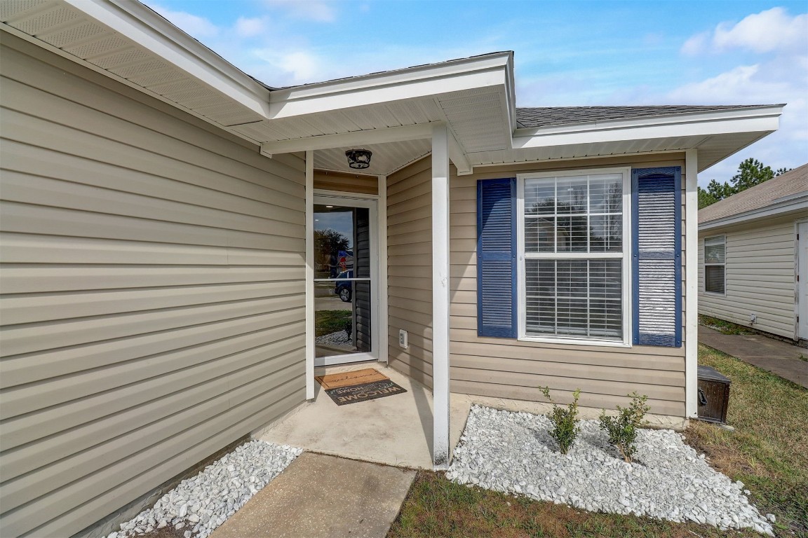 96099 Starlight Lane Yulee, FL 32097 - Photo 3 of 36 a view of a porch with a bench