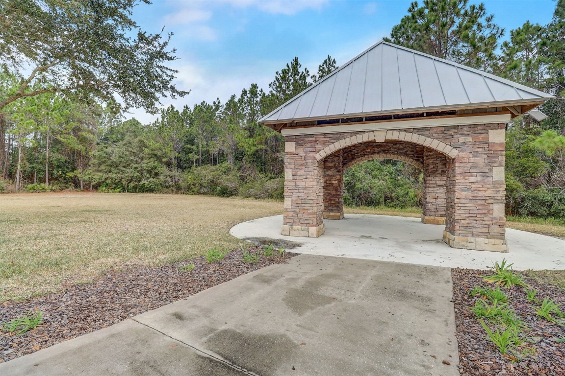 96099 Starlight Lane Yulee, FL 32097 - Photo 32 of 36 a front view of a house with garden