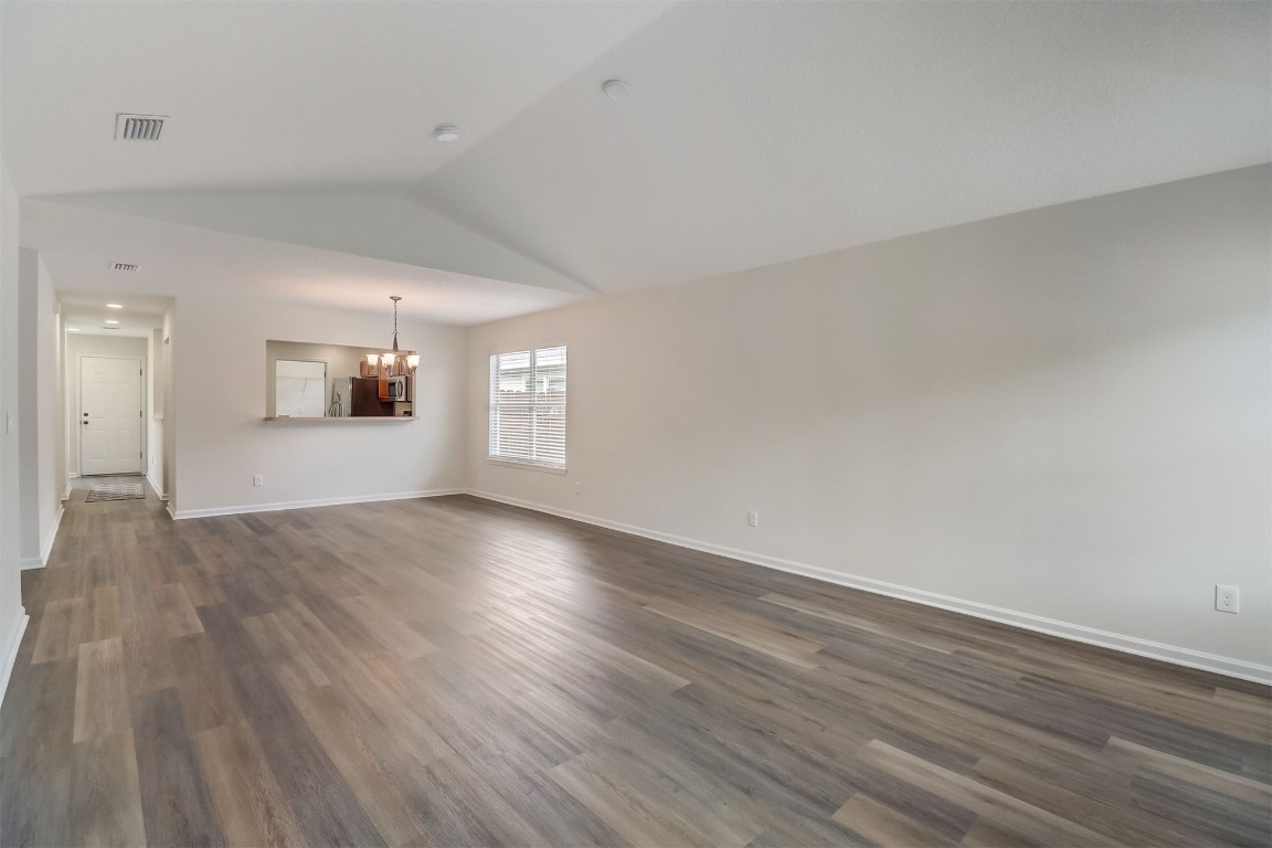 96099 Starlight Lane Yulee, FL 32097 - Photo 4 of 36 an empty room with wooden floor and windows